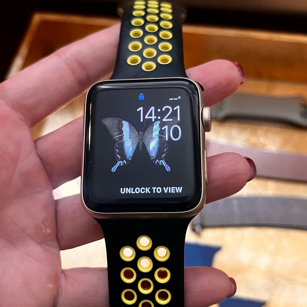 Apple Series 2 , size 42 mm . Smartwatch with Gold Case and Yellow-Black Band.